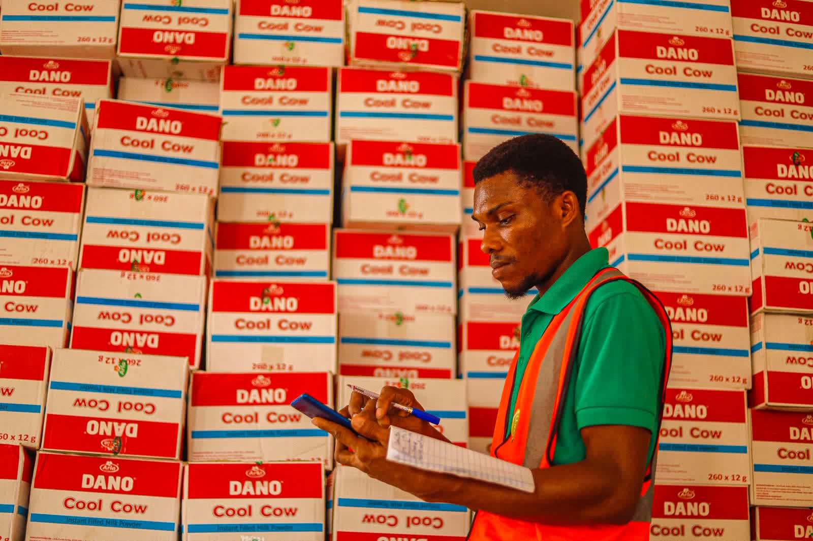 A stock officer checking boxes against a list in a store room